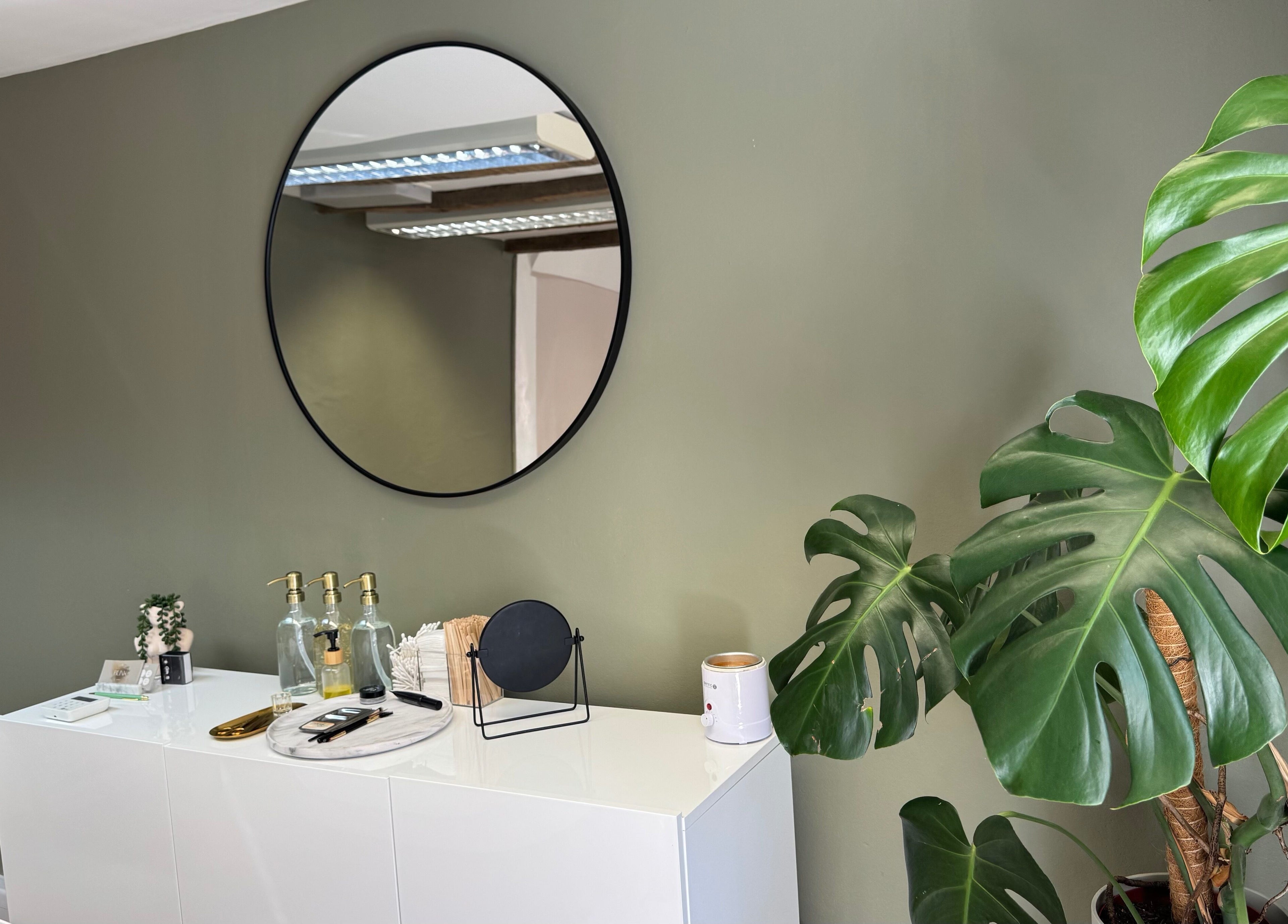 Minimalist decor with round mirror and plant at BL.INK STUDIO, Dereham, England, GB.