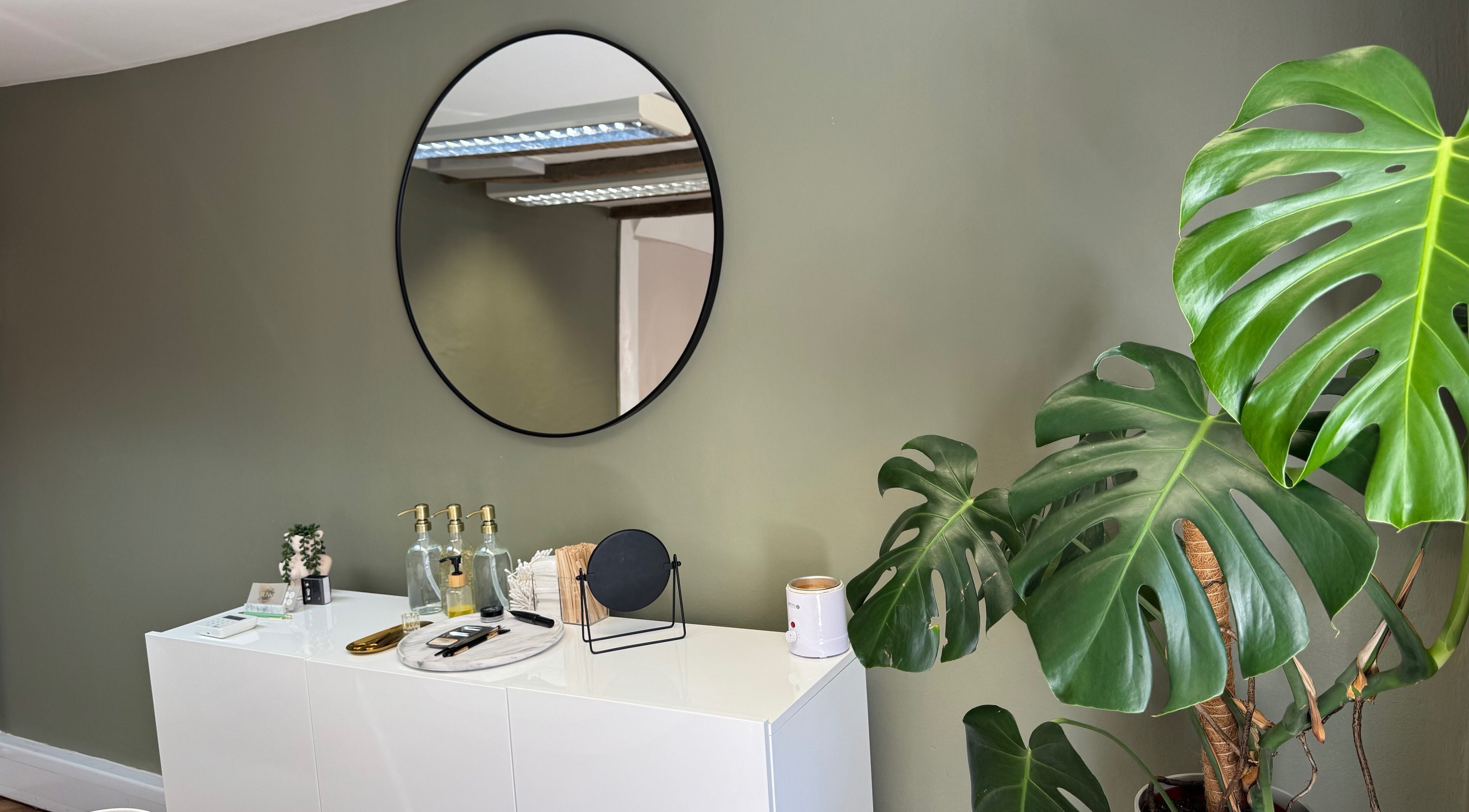 Minimalist decor with round mirror and plant at BL.INK STUDIO, Dereham, England, GB.