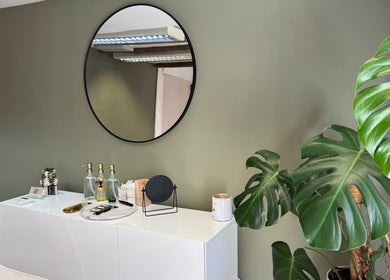 Elegant beauty space at BL.INK STUDIO, Fakenham, England, with mirror and leafy plant.