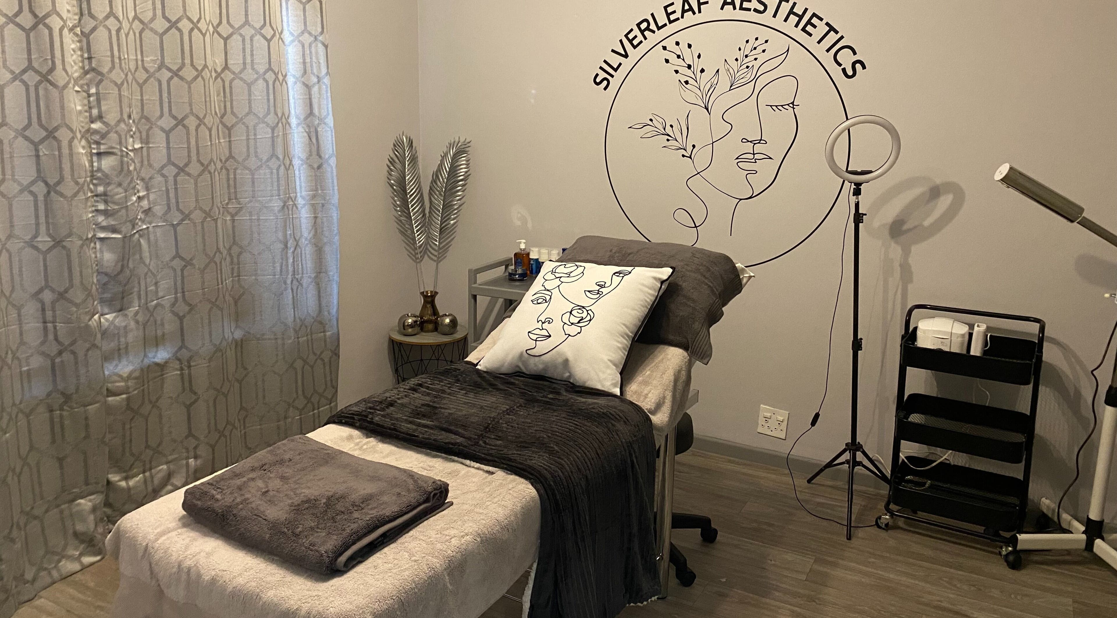 Elegant treatment room at SilverLeaf Aesthetics, Langebaan, Western Cape, ZA with plush bed and artistic decor.
