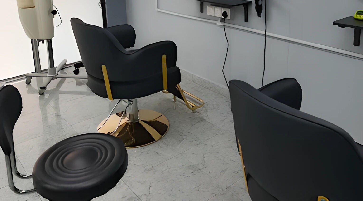 Modern salon chairs at Erma Hair Studio in Kangar, Perlis, MY, showcasing sleek interior design.