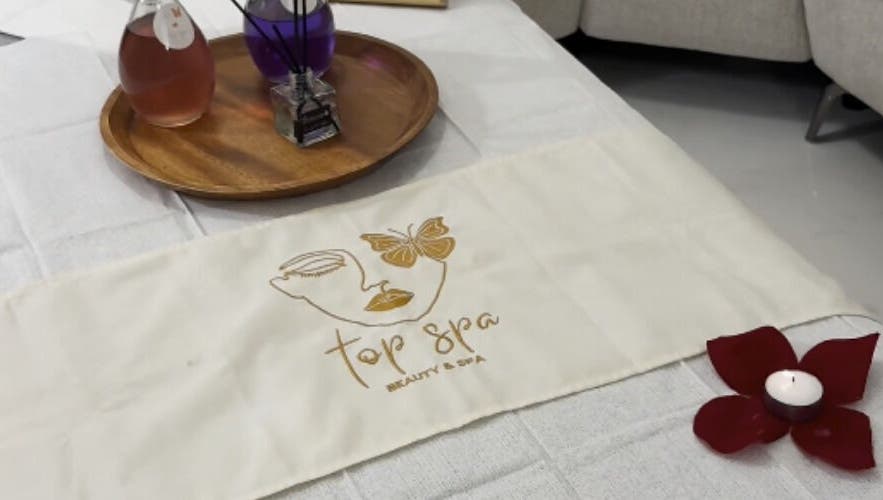 Calm spa setup at Top Spa Home Services توب سبا للنساء, Riyadh, Riyadh Province, SA with candle and oils.