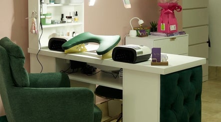 Clover Beauty Studio Limited nail station in Ennis, County Clare, IE featuring chic green seating and manicure tools.