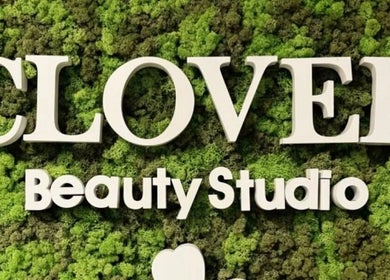 Lush green moss backdrop with Clover Beauty Studio Limited sign in Ennis, County Clare, IE.