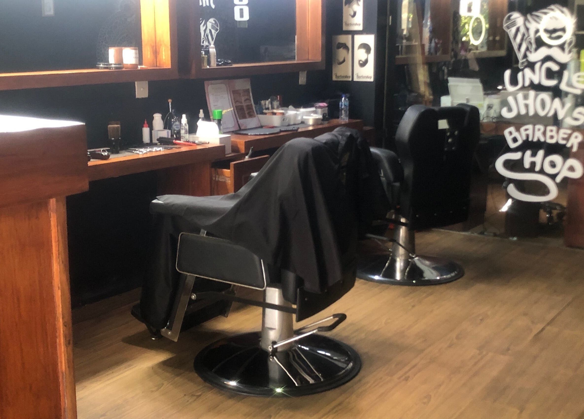 Cozy interior of Uncle Jhon’s Barber, Tattoo, Piercing, Lashes in Bali, Bali, ID with elegant barber chairs.