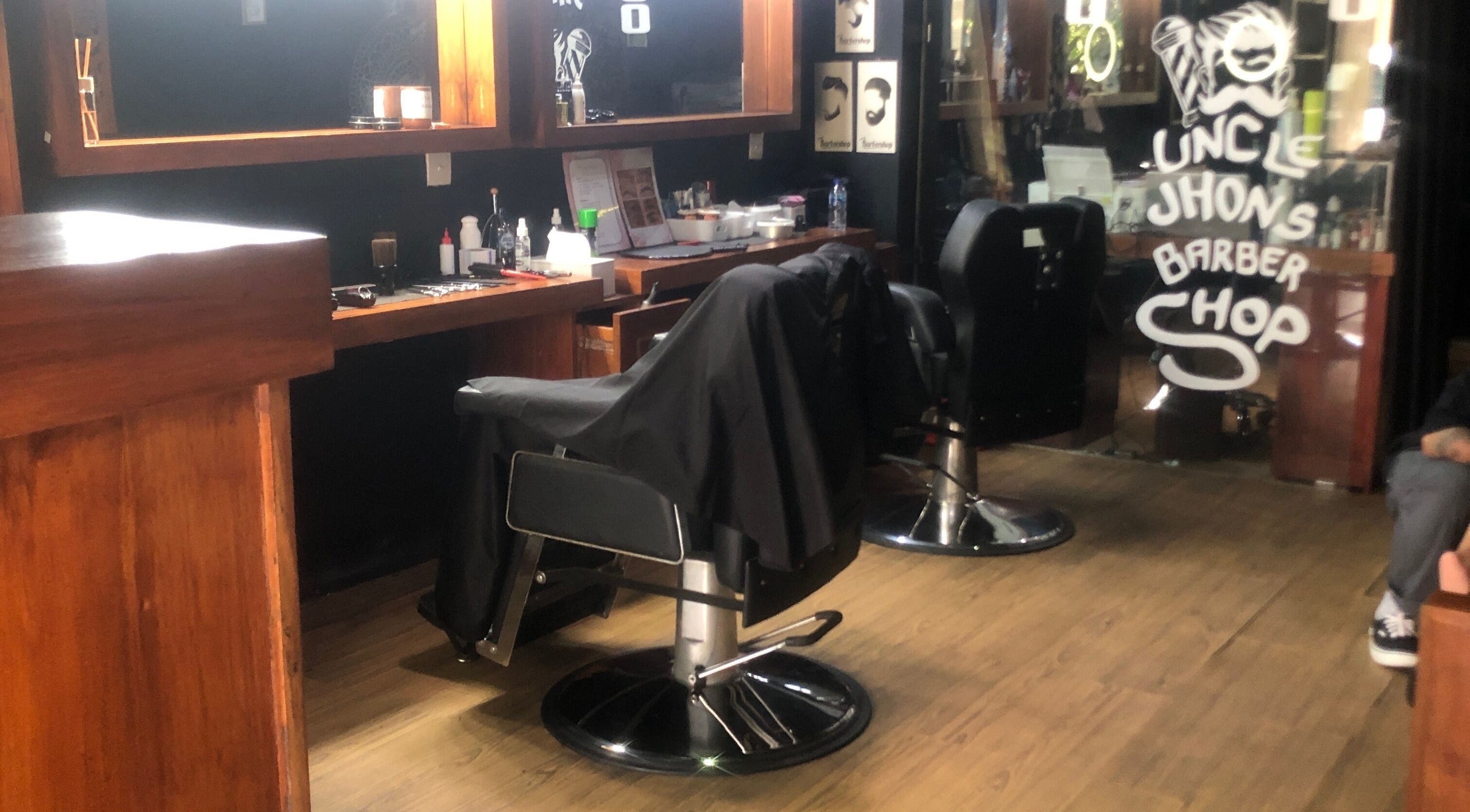 Cozy interior of Uncle Jhon’s Barber, Tattoo, Piercing, Lashes in Bali, Bali, ID with elegant barber chairs.