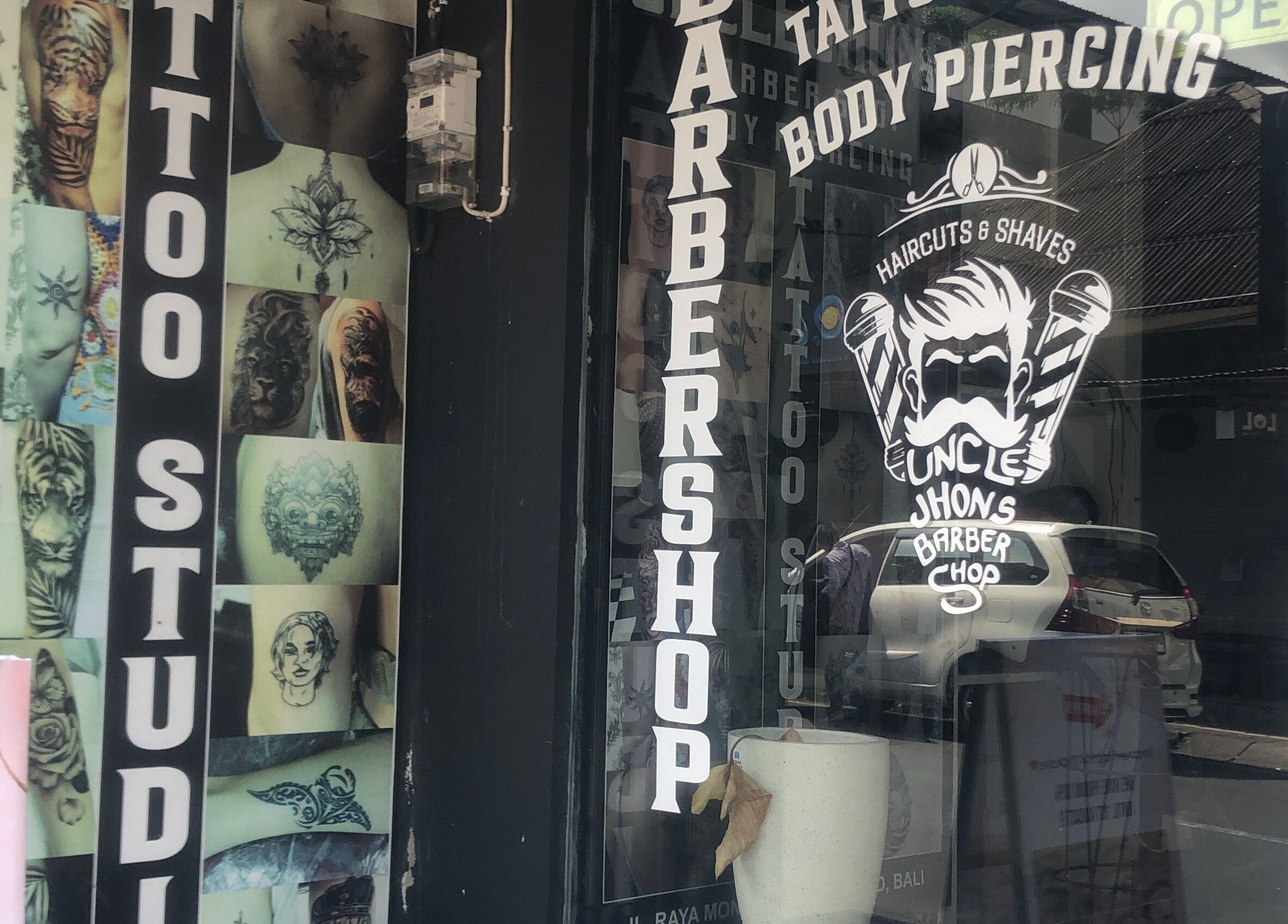 Uncle Jhon’s Barber, Tattoo, Piercing, Lashes facade featuring vibrant tattoo designs, Bali, Bali, ID.