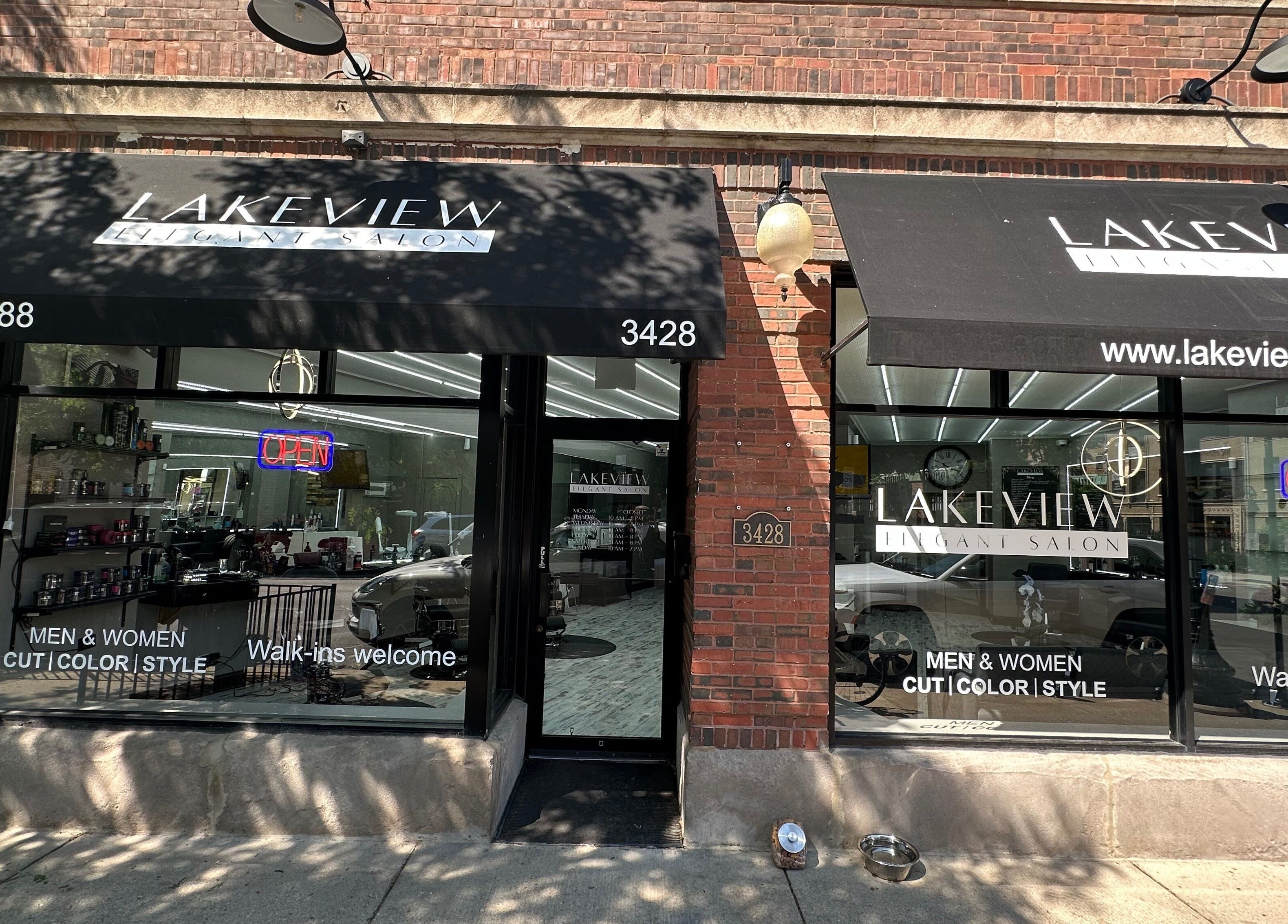 Front view of Lakeview Elegant Salon in Chicago, Illinois, US with stylish black awnings.