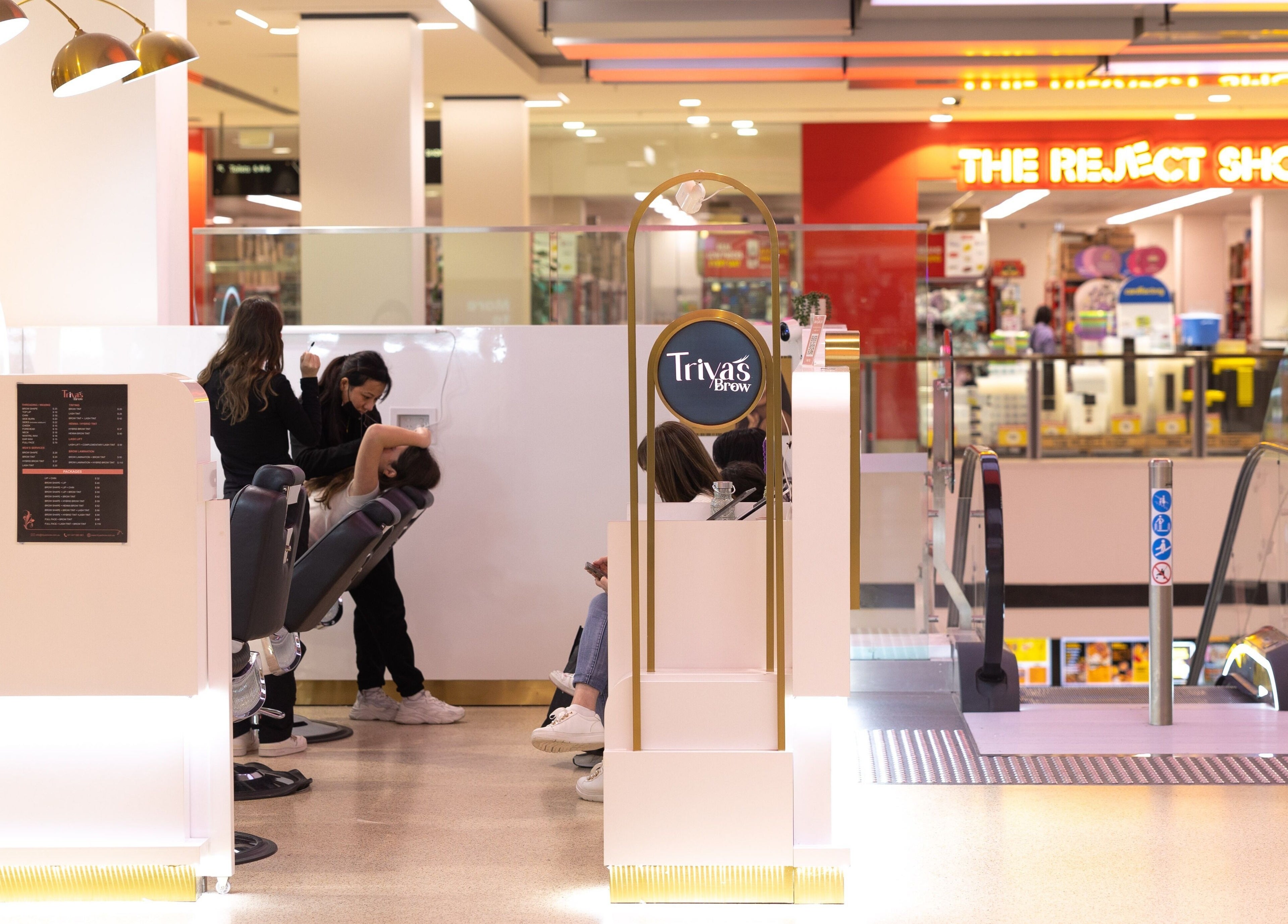 Inside Triya's Brows & Lashes at Bondi Junction, NSW, showcasing a sleek, modern beauty space with clients.