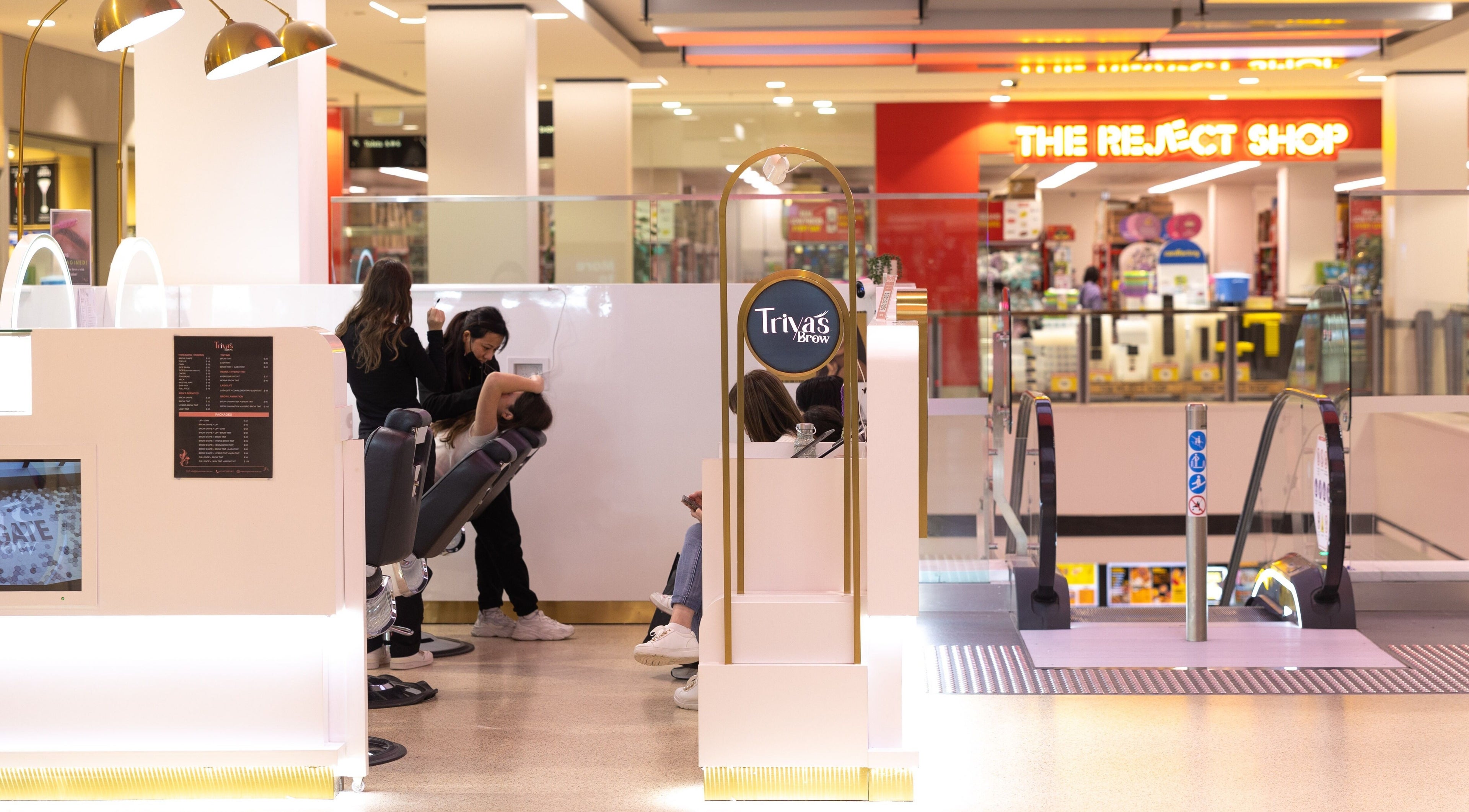 Inside Triya's Brows & Lashes at Bondi Junction, NSW, showcasing a sleek, modern beauty space with clients.