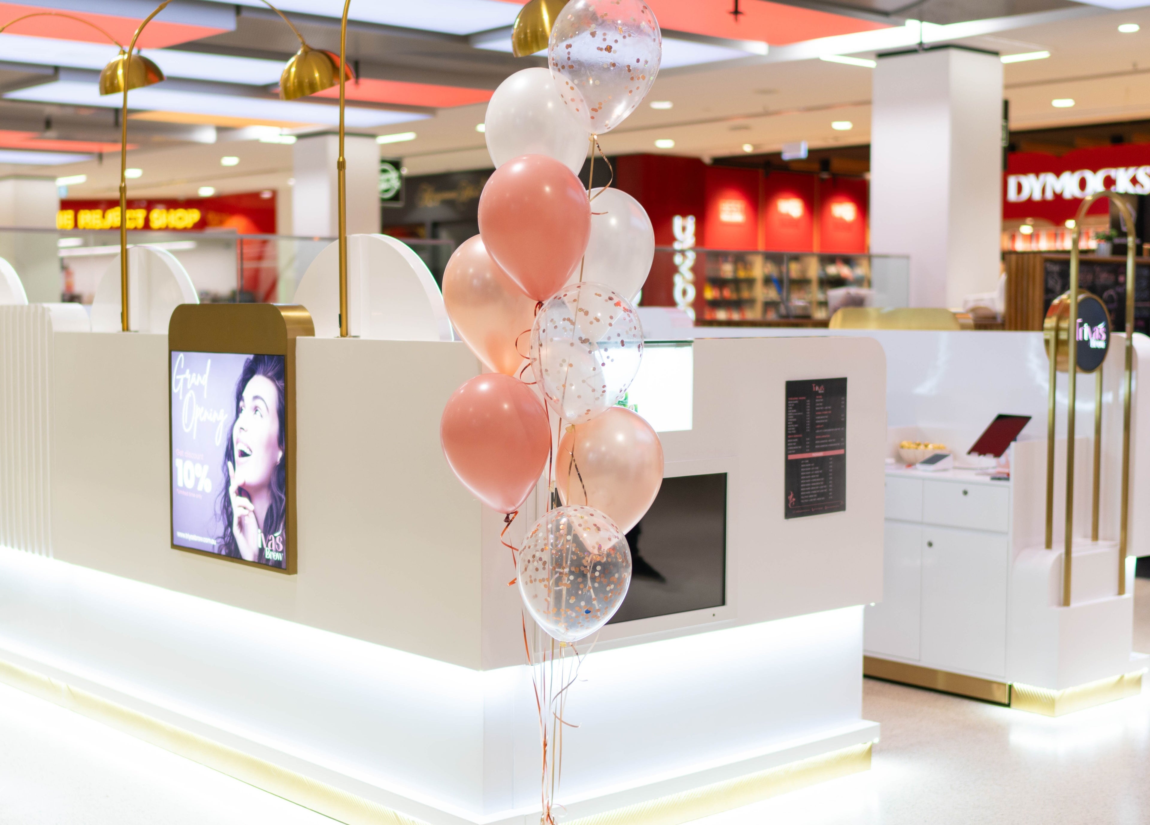 Triya's Brows & Lashes chic booth setup at Bondi Junction, New South Wales, AU, adorned with pastel balloons.