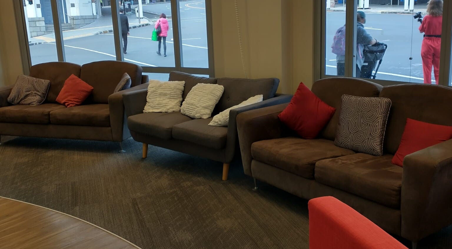 Comfortable seating area at Queens Beauty Clinic, Auckland, Auckland, NZ, with sofas and cushions.