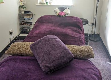 Tranquil massage room at AK Thai Solution Massage in Dudley, England, GB with plush purple towels.
