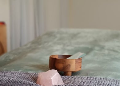Calming spa setup at Michaela's Holistic Beauty, Victoria, Victoria, AU featuring rose quartz and wooden bowl.