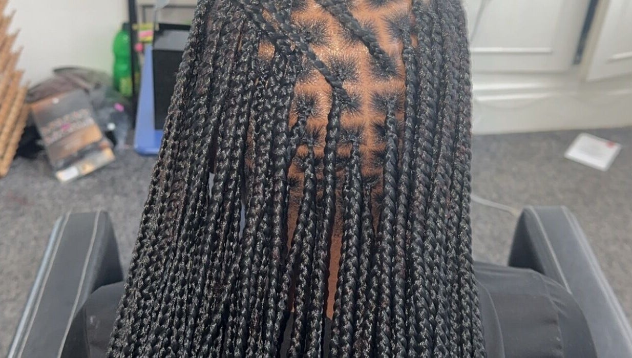 Intricate braids at Hairbyshile, Leicester, England, GB showcasing skilled hairstyling.