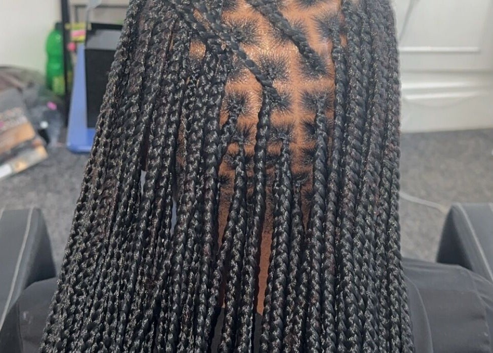 Intricate braids at Hairbyshile, Leicester, England, GB showcasing skilled hairstyling.