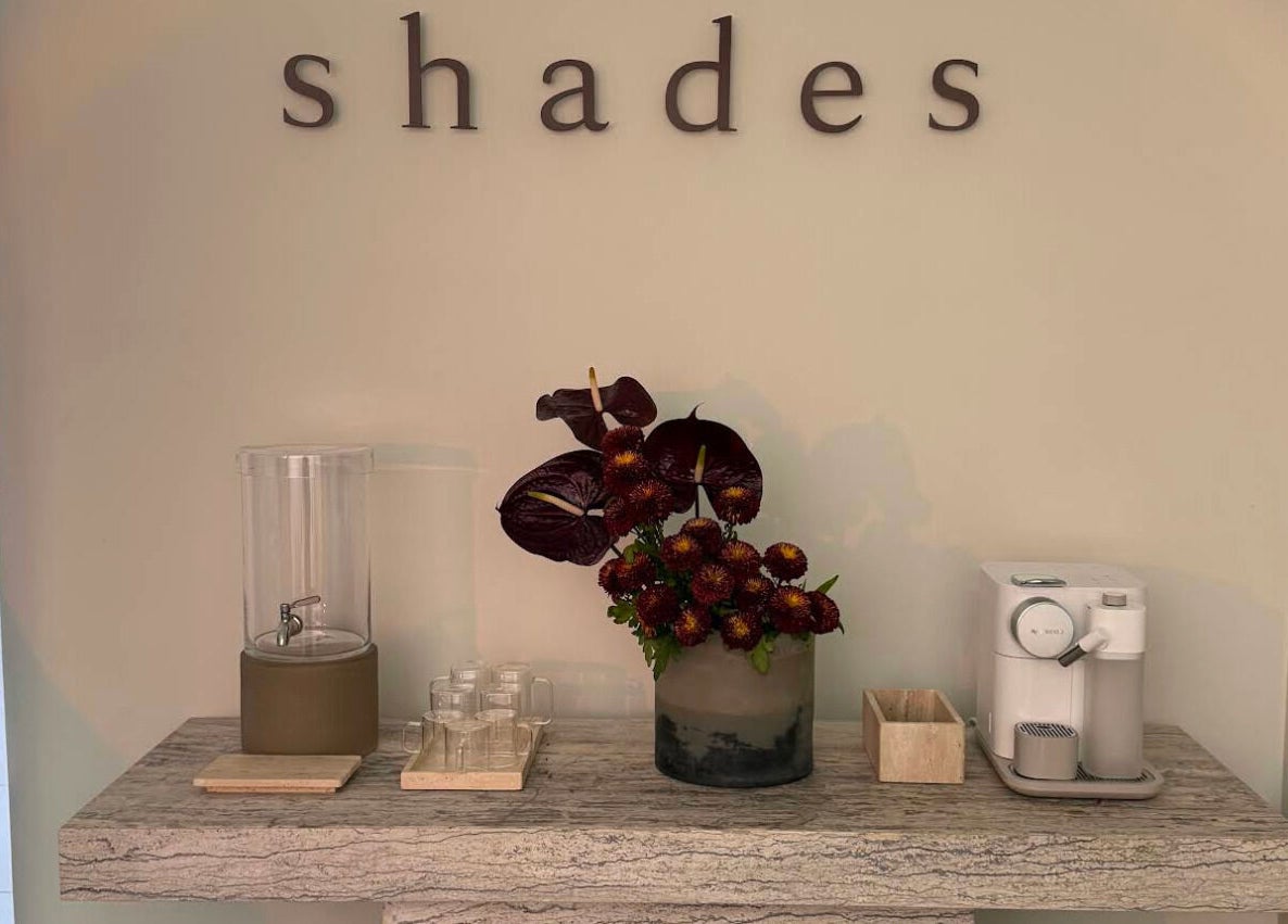 Elegant refreshment area at Shades by Ebtihal in Al Khobar, Eastern Province, SA with flowers and coffee machine.