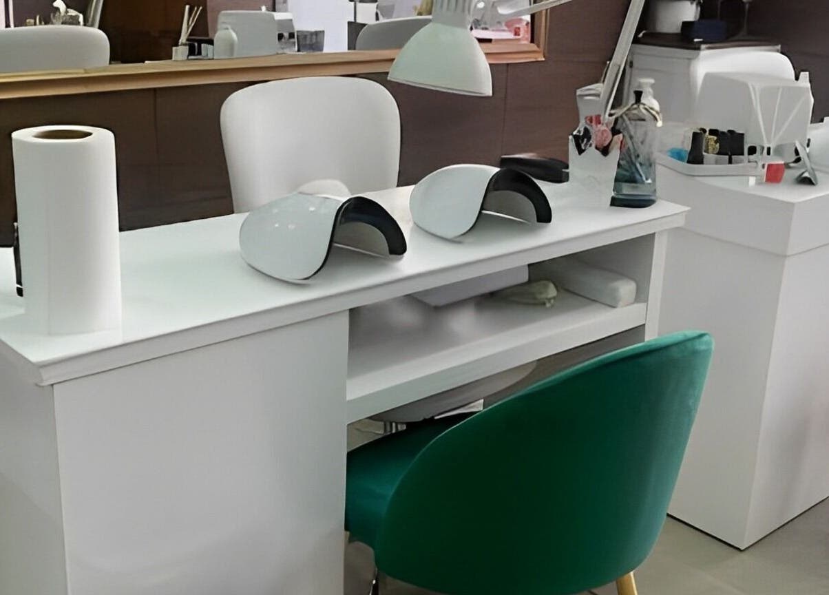 Estação de manicure moderna no Lamas Beauty Bar em Moscavide, Lisboa, PT com cadeiras confortáveis e lâmpadas UV.