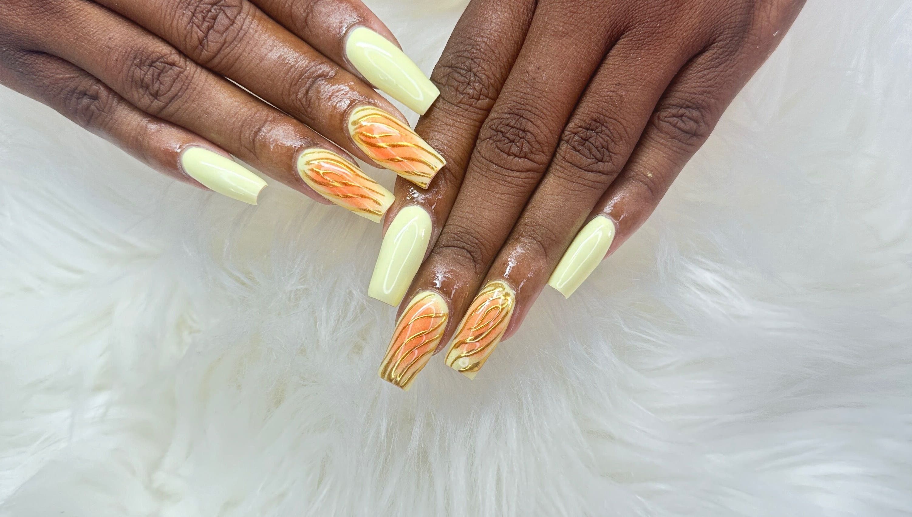 Elegant orange and cream nail art at Zuriah Nails & Cosmetics, Oistins, Christ Church, BB.