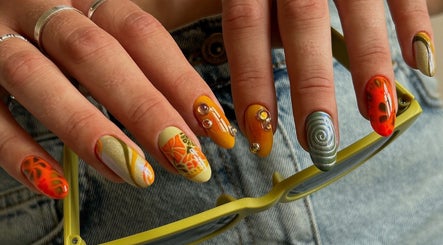 Colorful artistic nails at Phresh, Woodbridge, England, GB showcasing creative designs and gemstones.