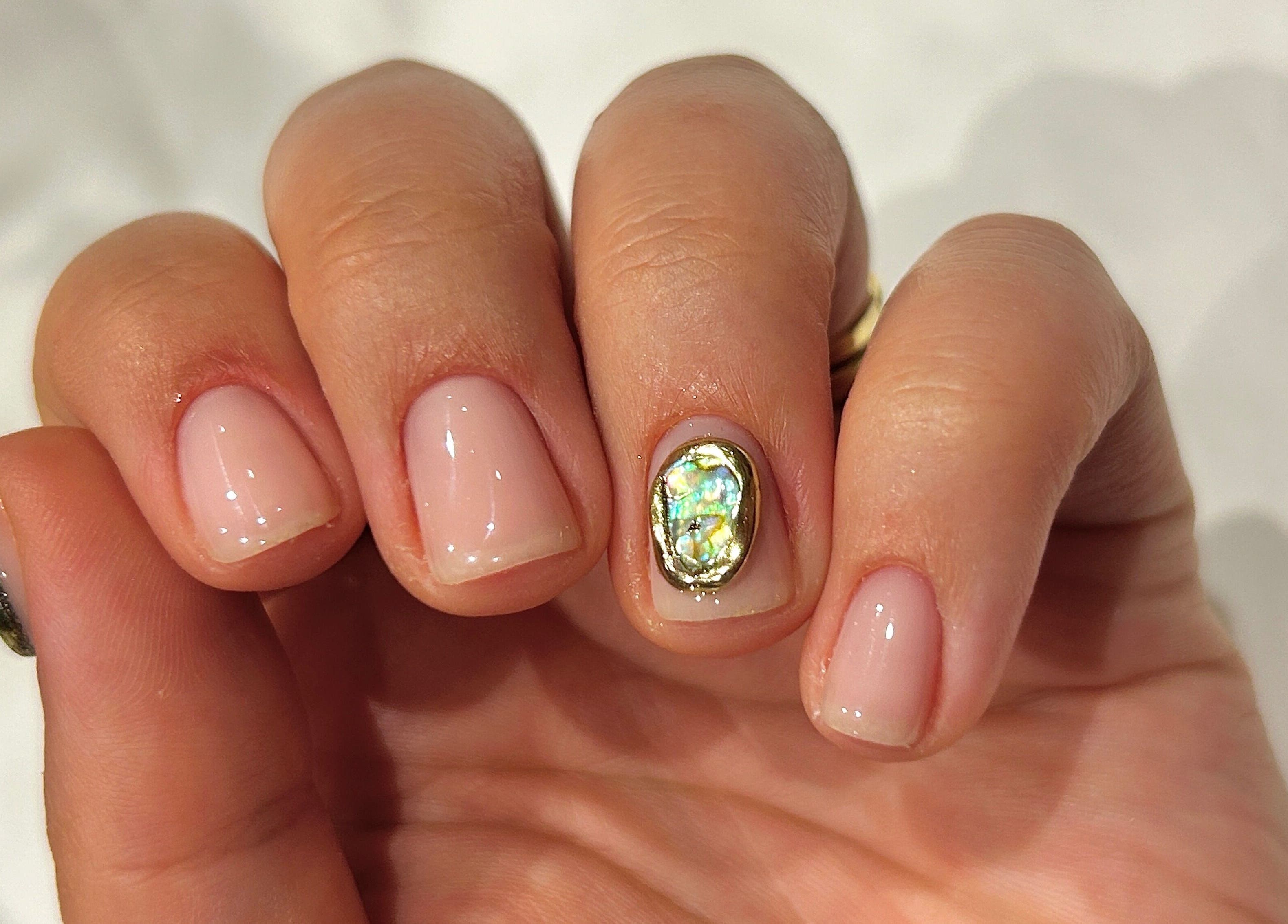 Gleaming manicure with opal gem at Phresh, Woodbridge, England, GB.