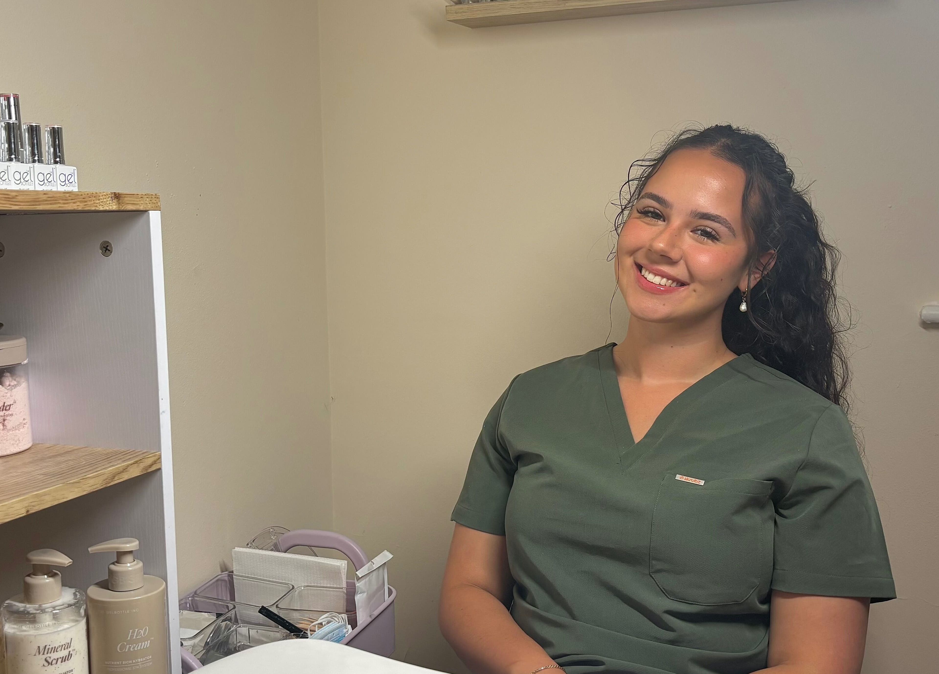 Phresh beauty therapist in uniform at Woodbridge, England, GB, ready to assist clients with top-notch services.