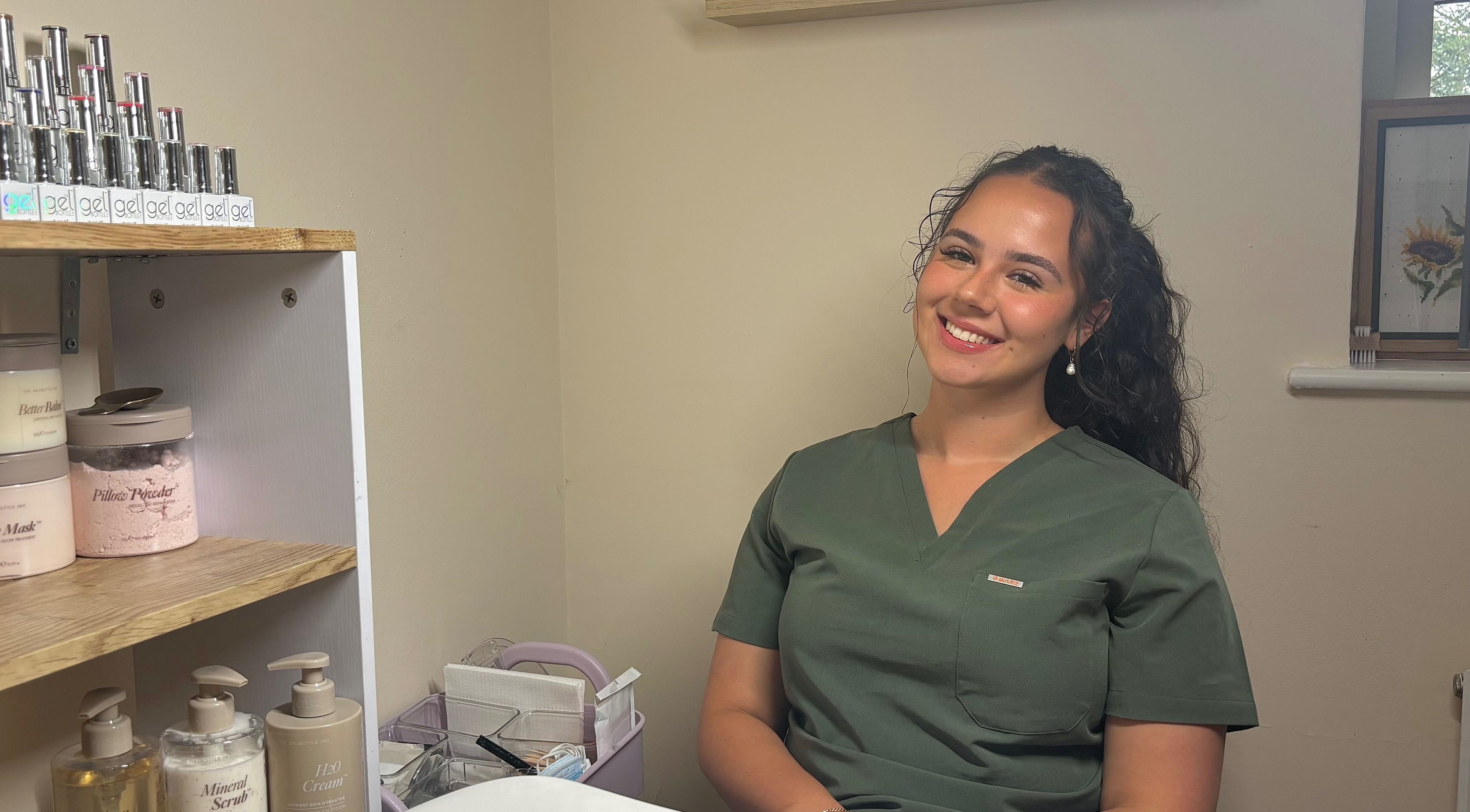 Phresh beauty therapist in uniform at Woodbridge, England, GB, ready to assist clients with top-notch services.