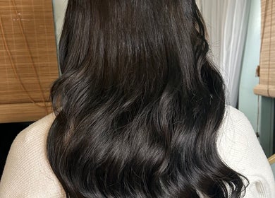Long wavy dark hair styled at Locks and Lashes, Cambridge, England, GB.