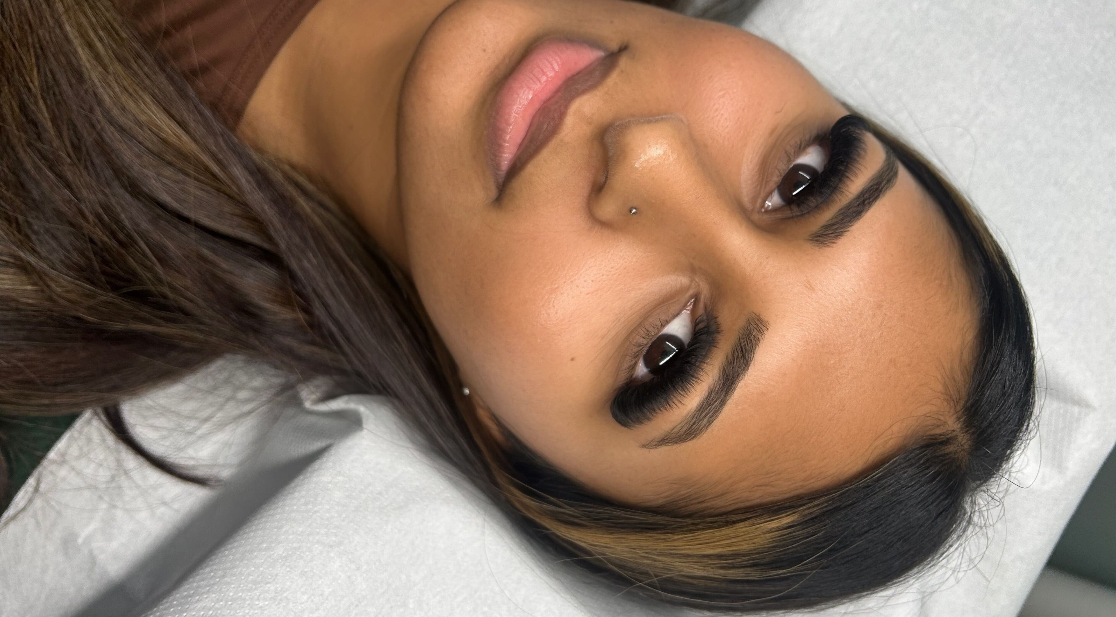 Close-up of a woman with beautiful eyelashes at Locks and Lashes, Cambridge, England, GB.