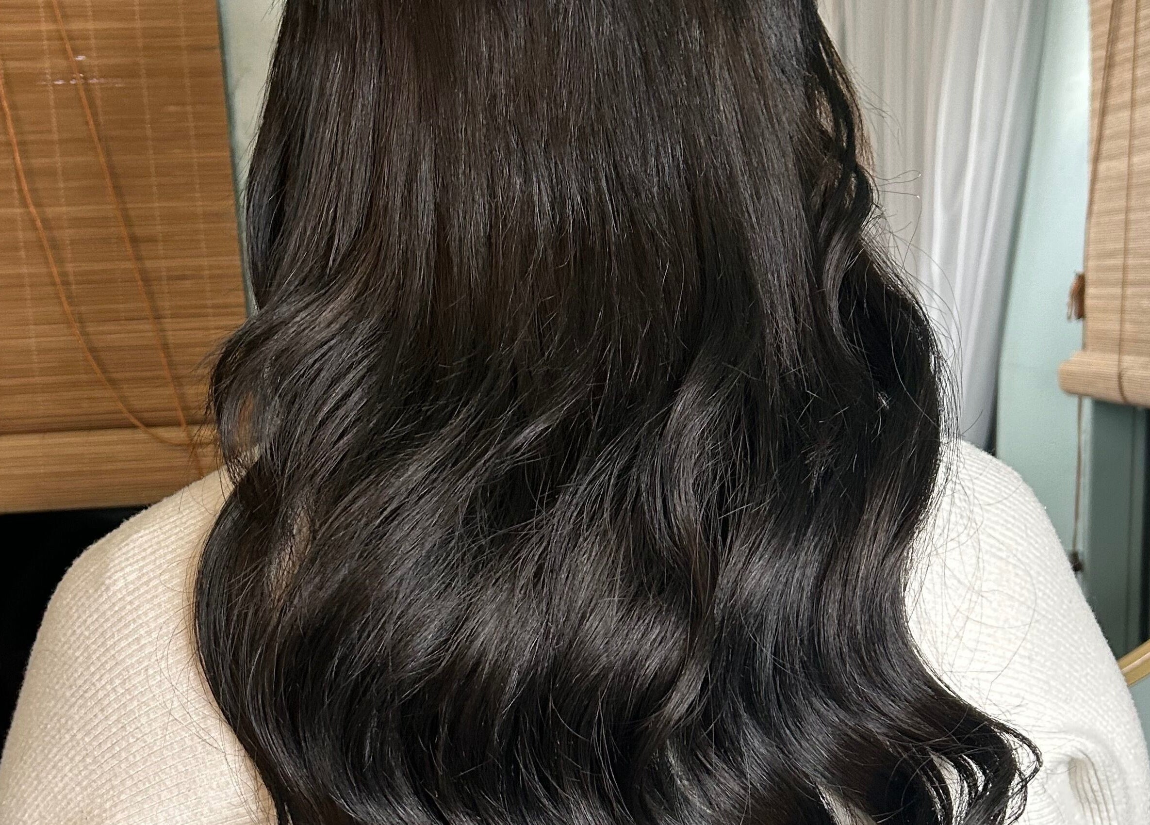 Elegant wavy hairstyle at Locks and Lashes, Cambridge, England, GB, showcasing rich brown tones.