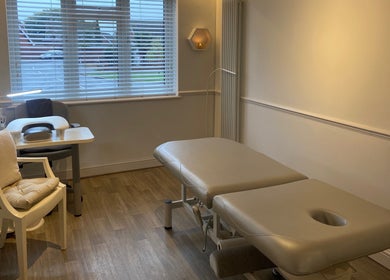 Spacious treatment room at Wanderlust Beauty & Foot Health in Westoning, England, GB, featuring cozy decor.