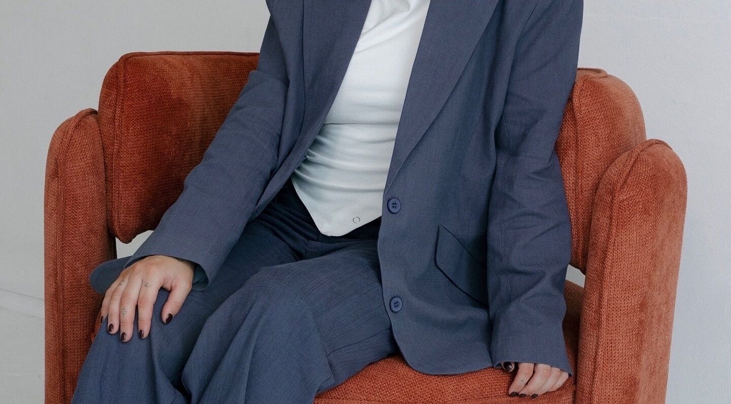 Person in blue suit seated on a cozy chair at Hair.ByTayah, Berkeley Vale, New South Wales, AU.