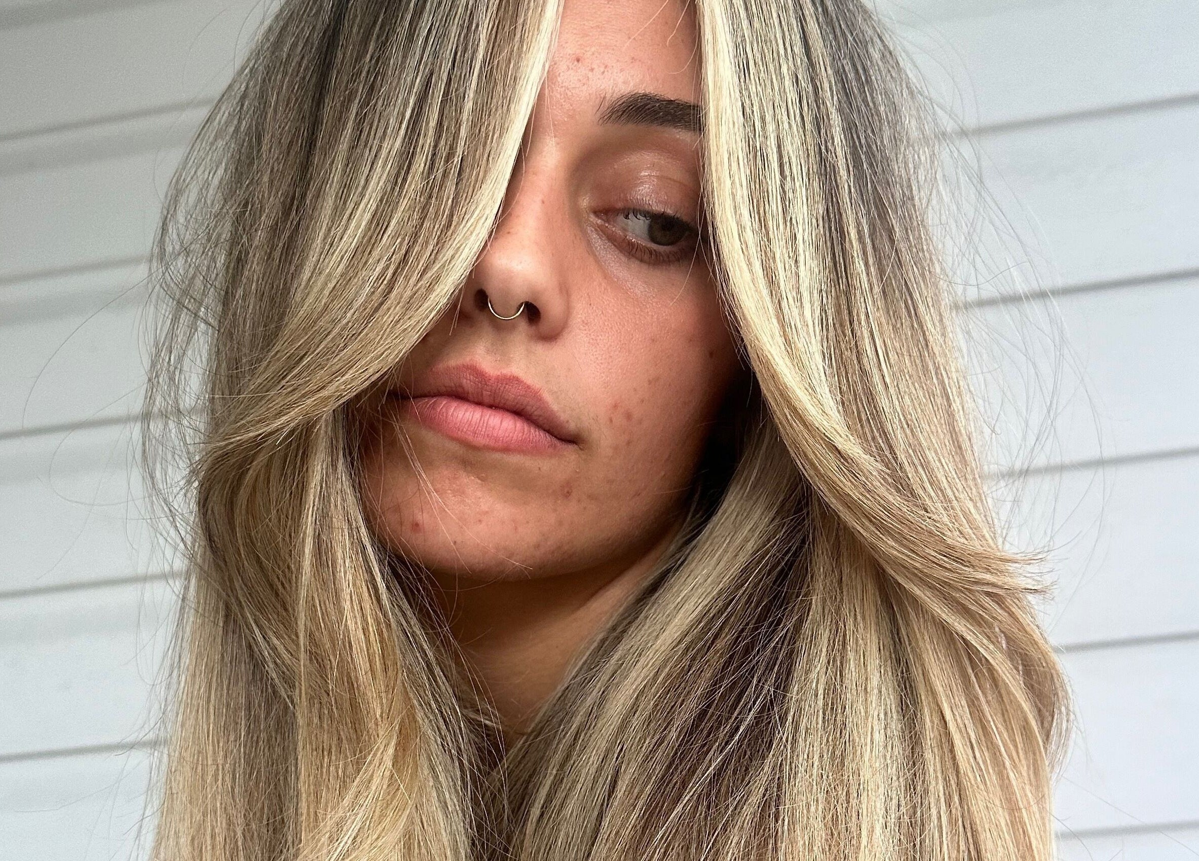 Woman with stylish blonde highlights at Hair.ByTayah, Berkeley Vale, New South Wales, AU.