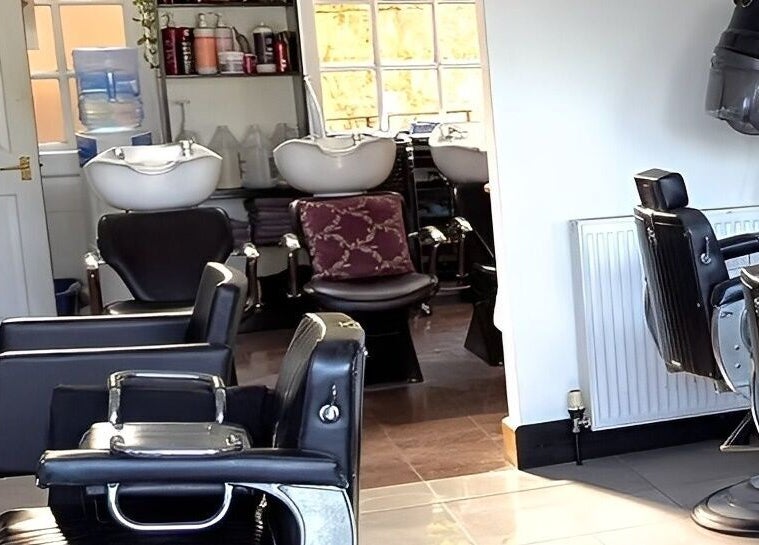 Modern salon interior with black chairs at Giuseppe’s of Bath, Bath, England, GB.