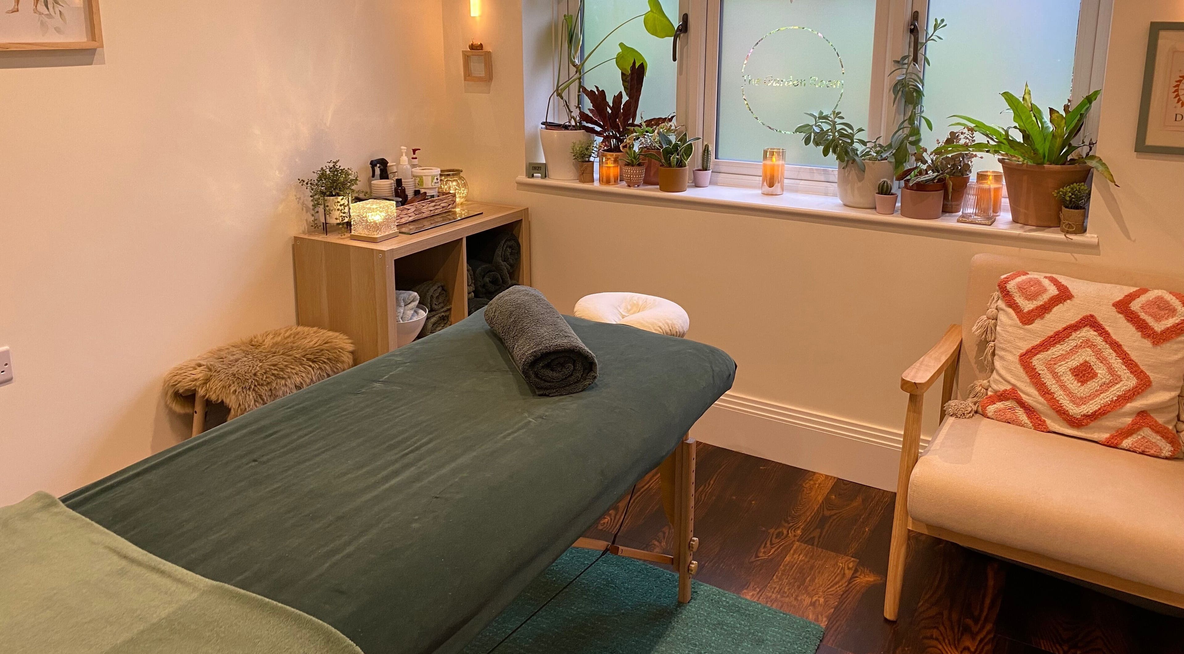 Relaxing massage room with warm lighting at The Garden Room, Milton Keynes, England, GB.