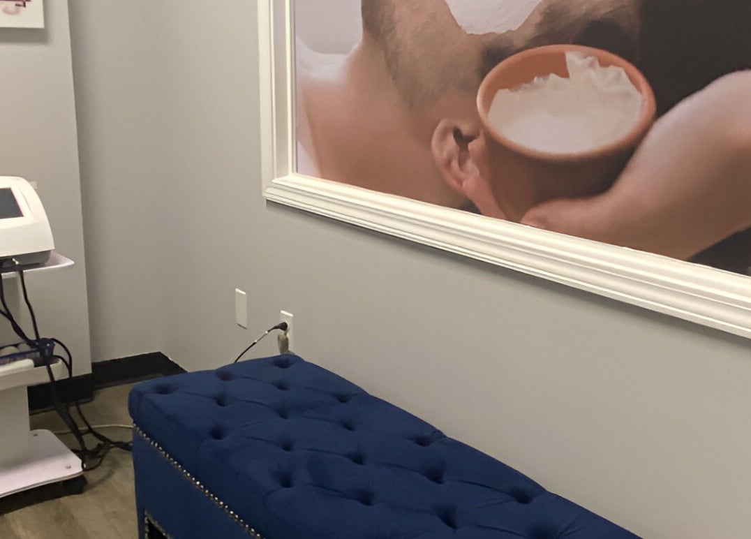 Modern massage room at Gorgeous Ever Center, Roswell, Georgia, US with treatment machine and art.