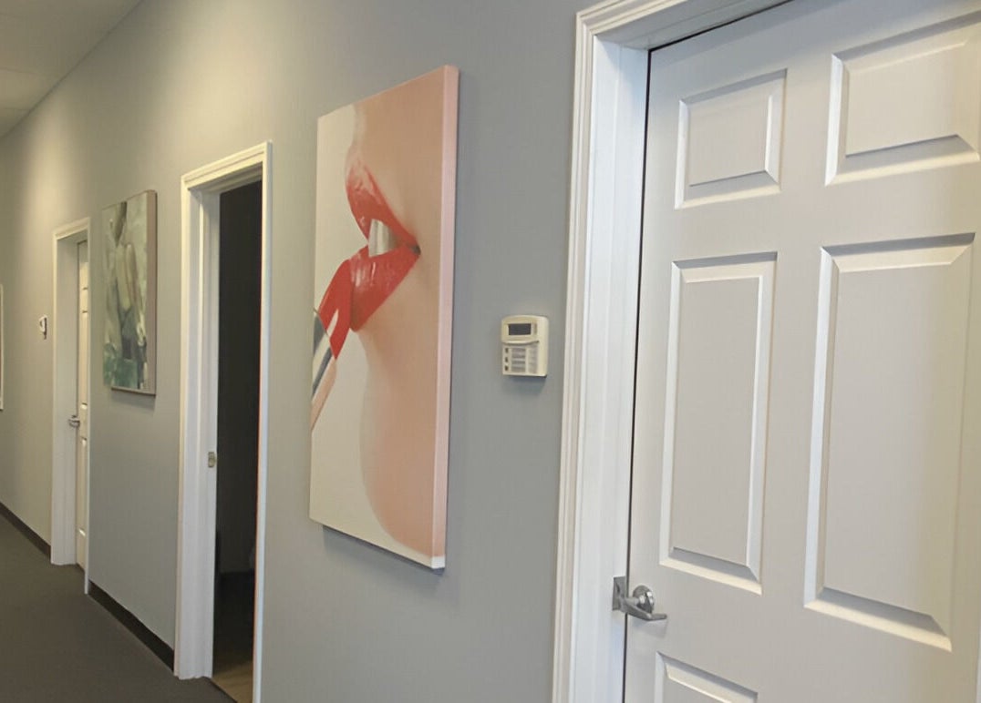 Chic hallway at Gorgeous Ever Center in Roswell, Georgia, US, featuring stylish artwork and modern decor.