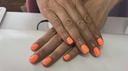 Bright coral nails expertly done at NextLevelNails in Northleach, England, GB, showcasing vibrant elegance.