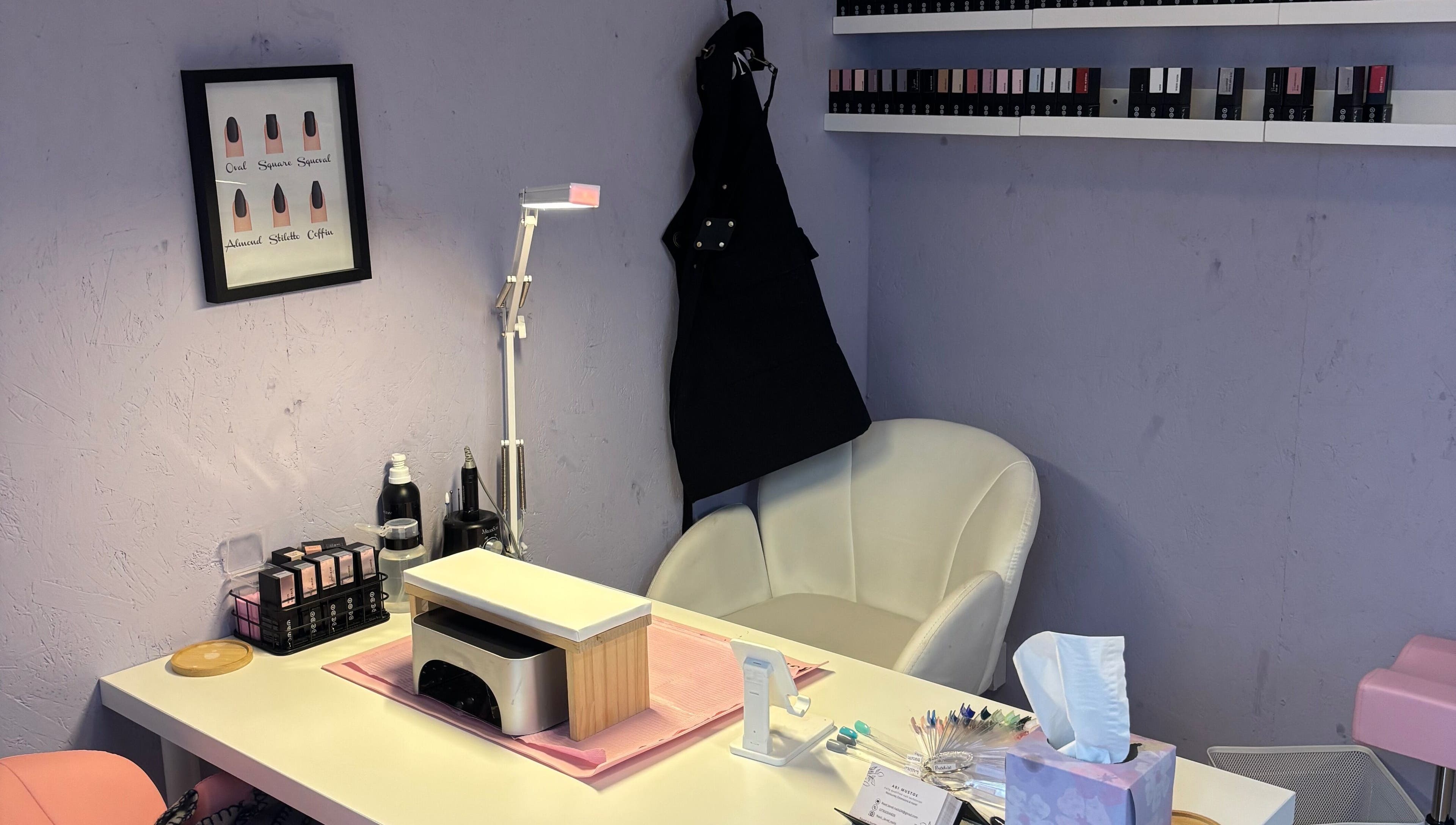 Cozy nail station at Next Level Nails, Northleach, England, GB, featuring plush chair and manicure tools.