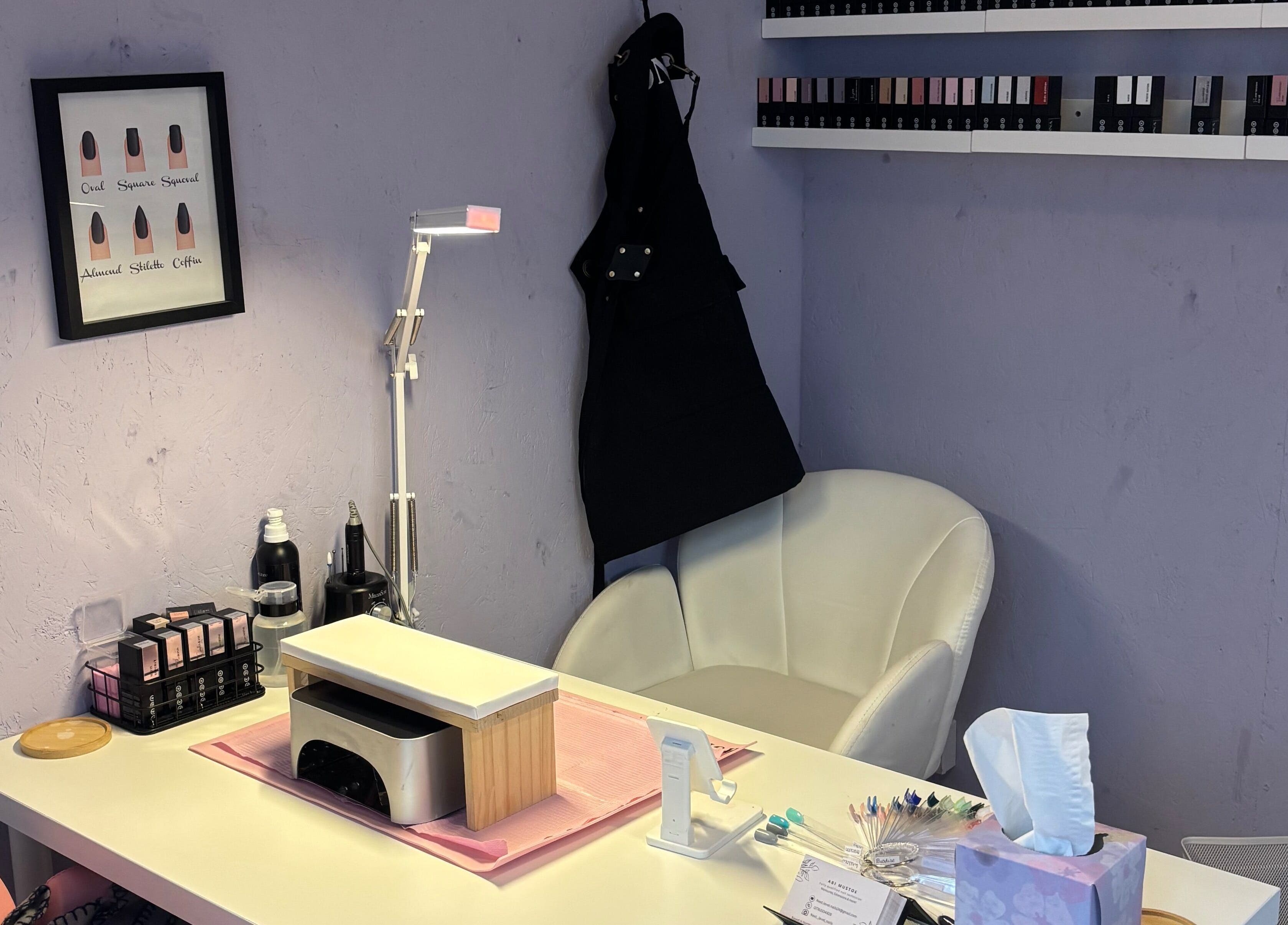 Cozy nail station at Next Level Nails, Northleach, England, GB, featuring plush chair and manicure tools.
