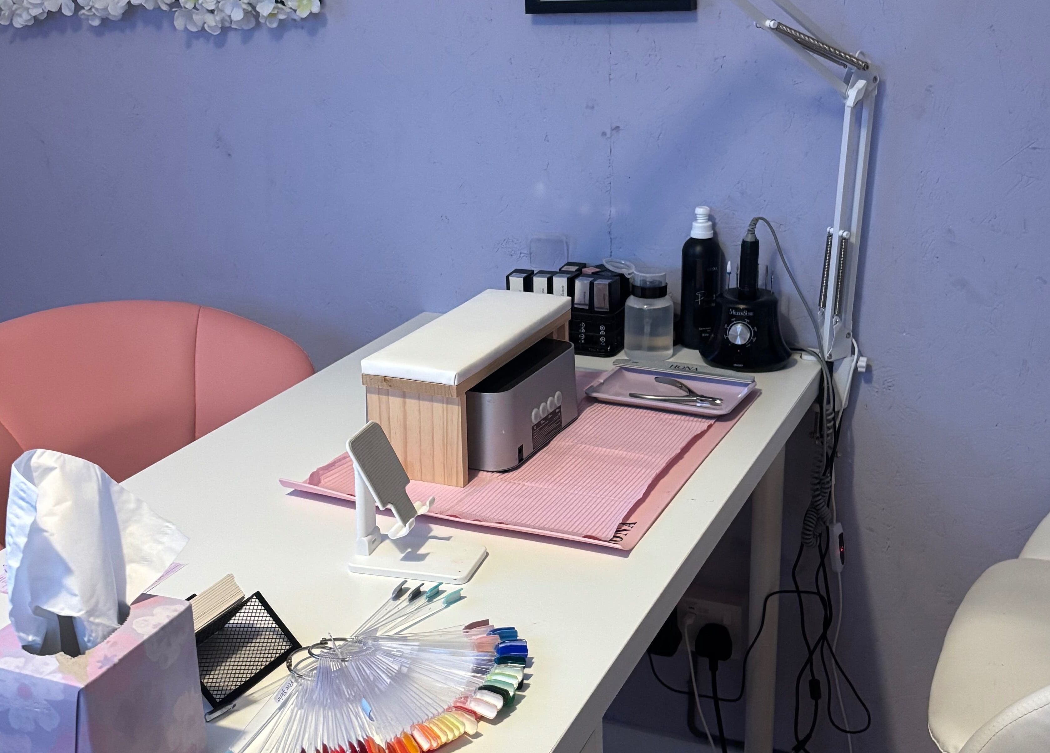 Elegant nail station at Next Level Nails, Northleach, England, GB, featuring tools and polish options.