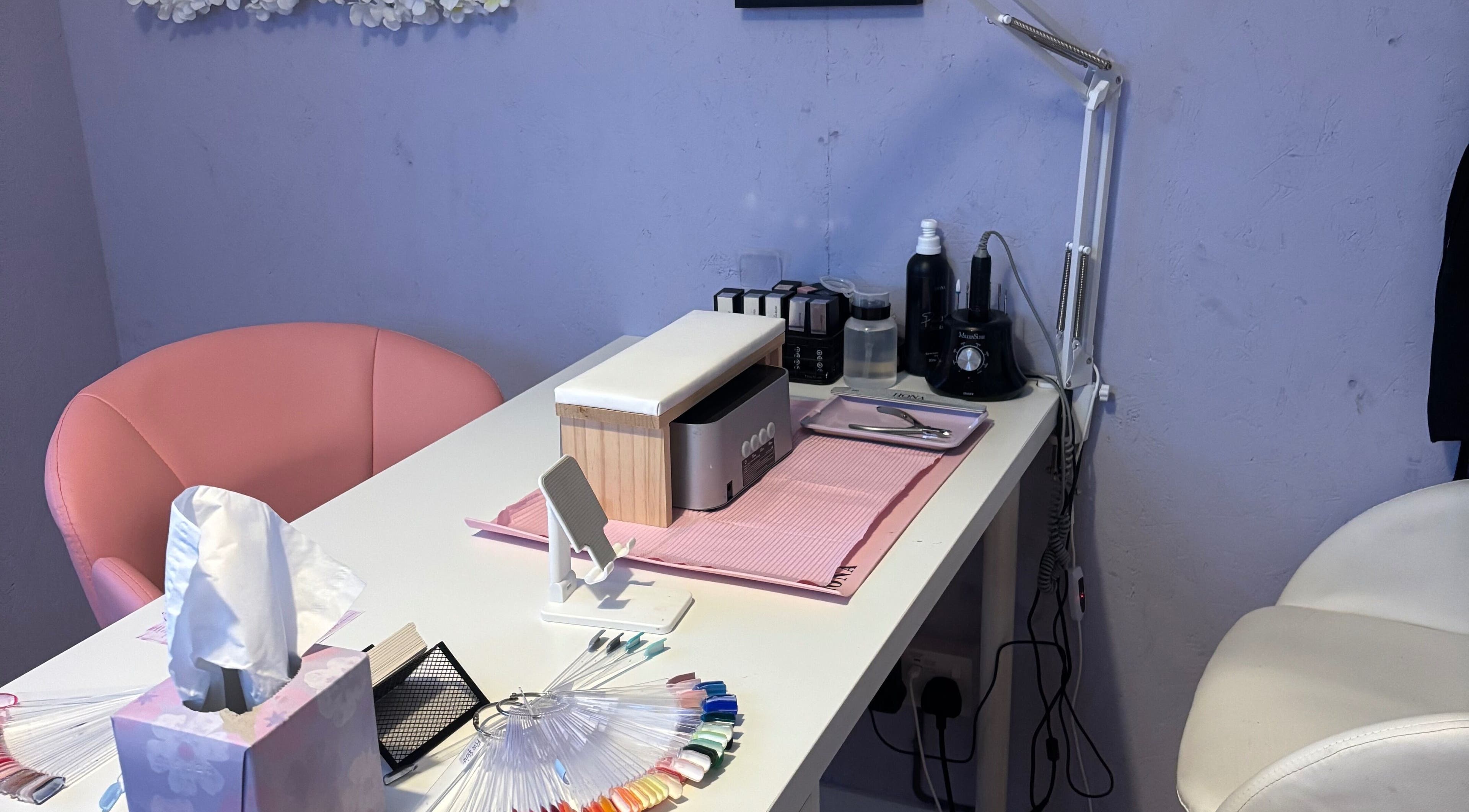 Elegant nail station at Next Level Nails, Northleach, England, GB, featuring tools and polish options.