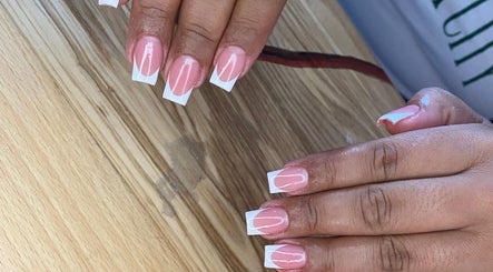 Beautiful French manicure at AllurebeautybyC_ in Cape Town, Western Cape, ZA with a wooden background.