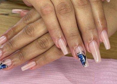 Elegant nude nails with blue butterfly art at AllurebeautybyC_, Cape Town, Western Cape, ZA.