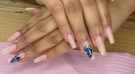 Elegant nude nails with blue butterfly art at AllurebeautybyC_, Cape Town, Western Cape, ZA.