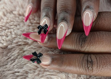 Stunning pink stiletto nails with bow accents at X Nails and Beauty, Ballito, Kwazulu-natal, ZA.