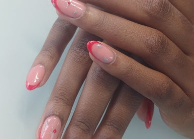 Stylish nail art with red tips at X Nails and Beauty, Ballito, Kwazulu-natal, ZA.