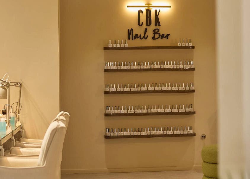 CBK Beauty Flagship Salon's chic nail bar in Accra, Greater Accra Region, GH, with modern décor and nail polish display.