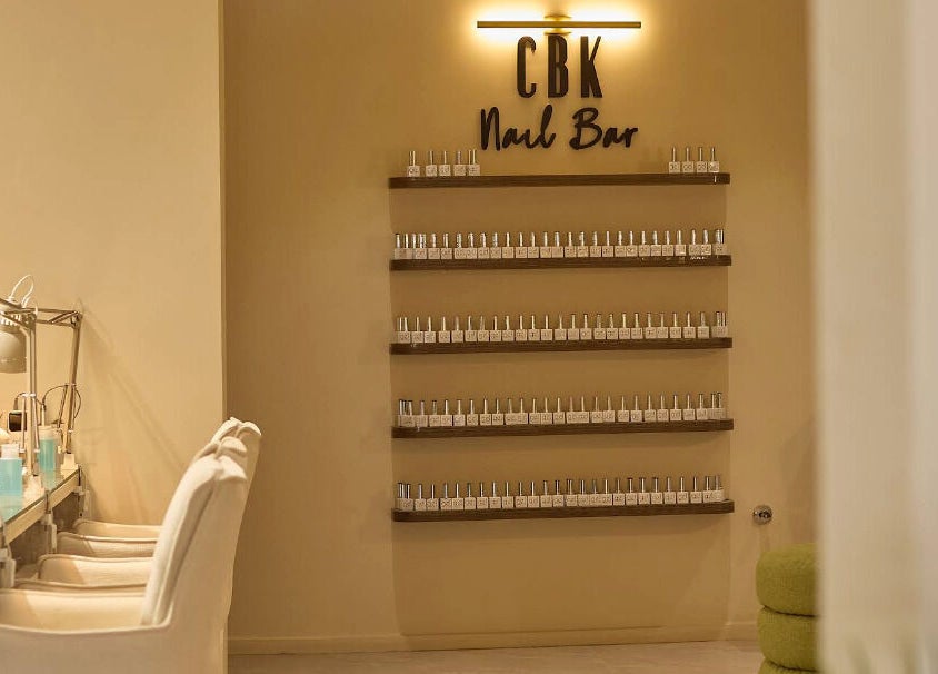 CBK Beauty Flagship Salon's chic nail bar in Accra, Greater Accra Region, GH, with modern décor and nail polish display.