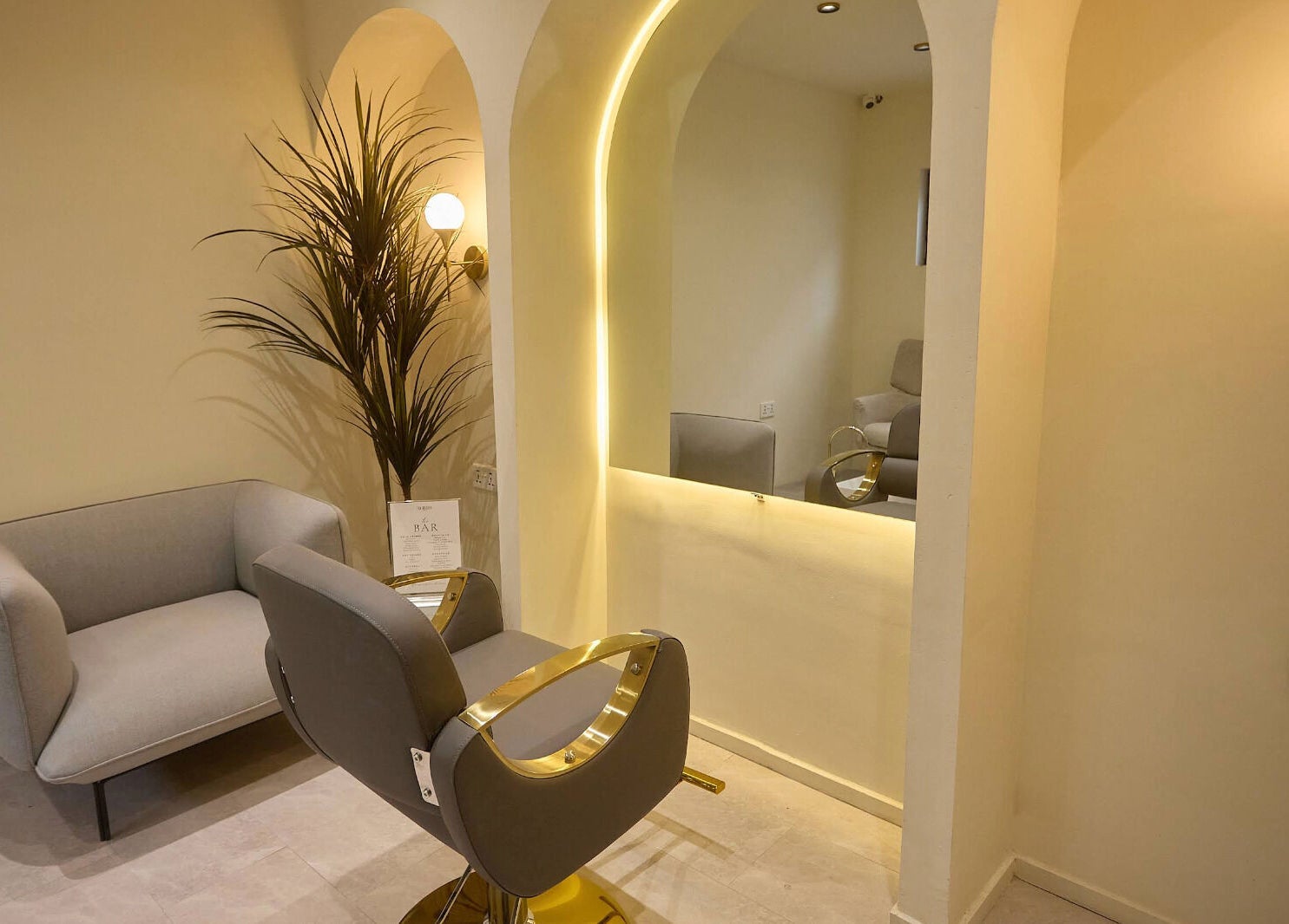 A cozy styling area in CBK Beauty Flagship Salon, Accra, Greater Accra Region, GH with chic seating and modern lighting.